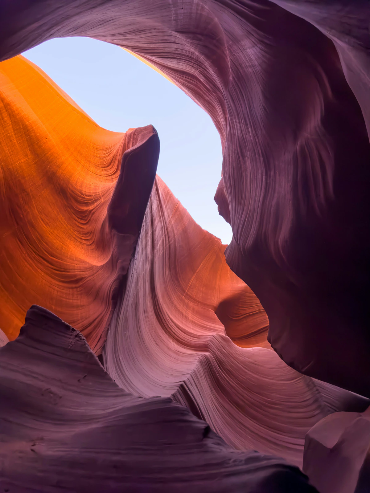 Tall sandstone formations rising toward the sky inside Antelope Canyon